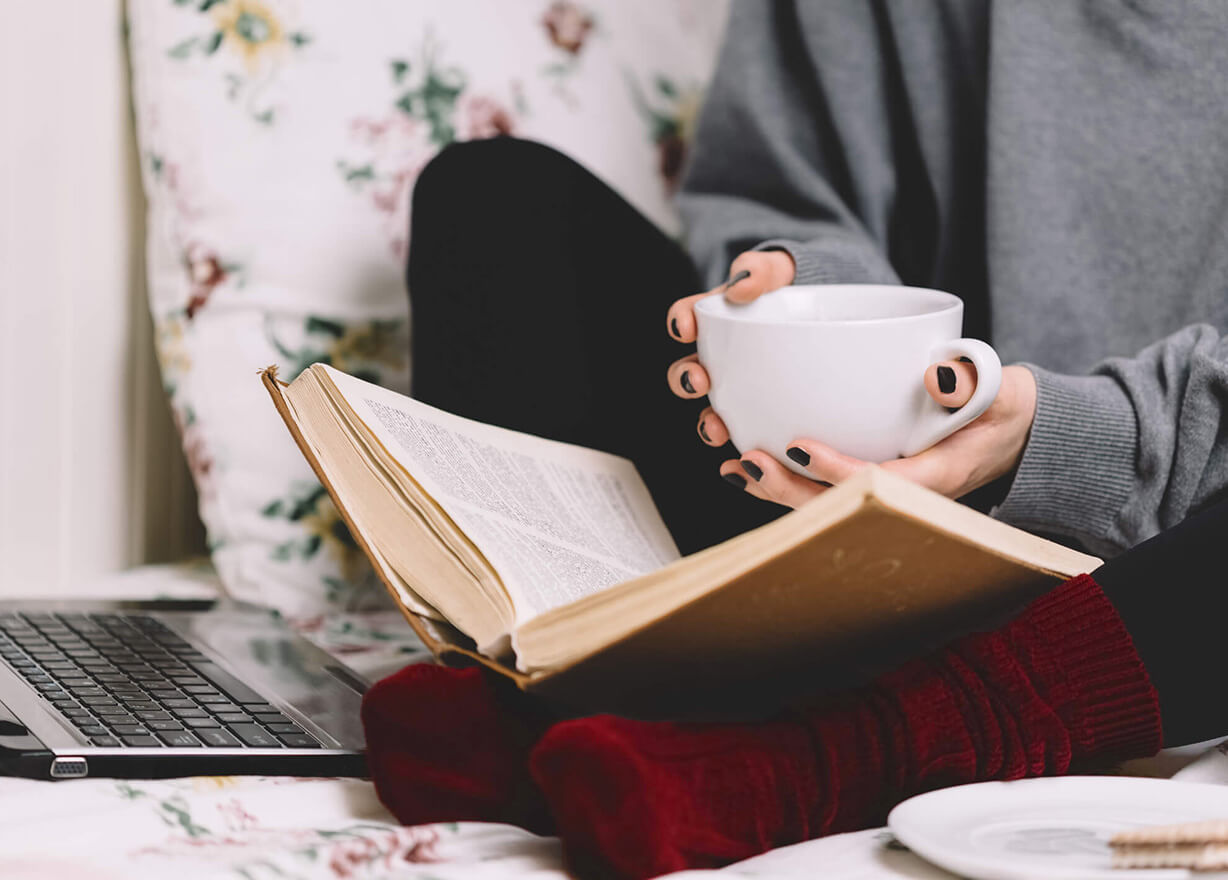Lady reading with a cup of tea