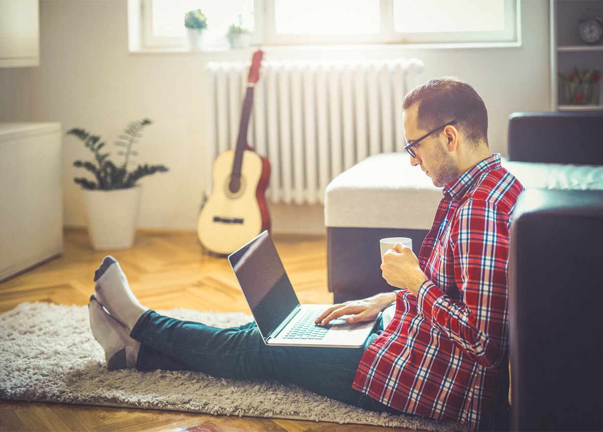 Man sat on floor with laptop