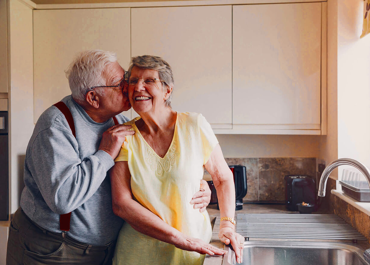 Elderly couple kissing
