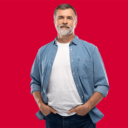 Man in denim shirt with hands in his pocket