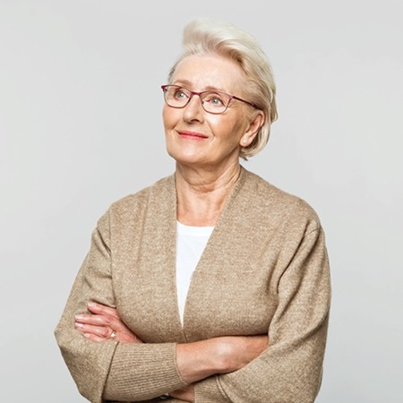 Mature woman with arms crossed looking ahead
