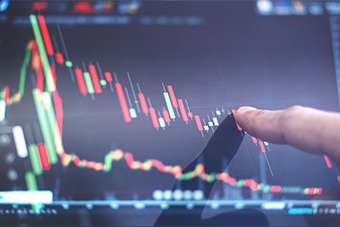 finger pointing at stock graph