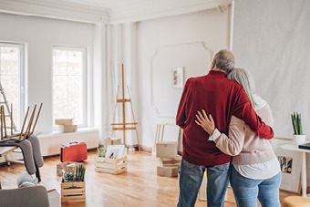 A couple hugging while decorating a room