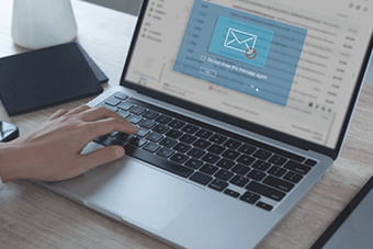 person typing on laptop with email interception notification