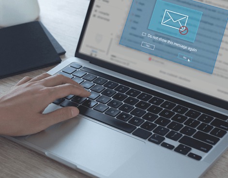 man typing on laptop with email interception notification pop up
