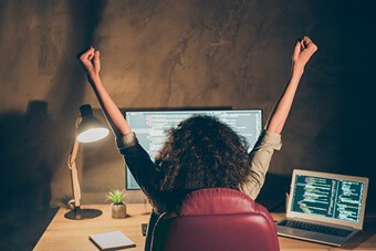 Woman sat at a desk working late on a computer