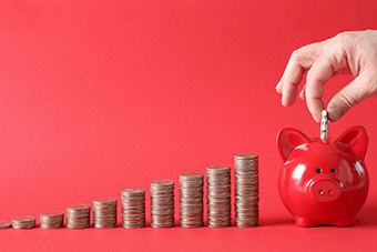Coins going into a money bank