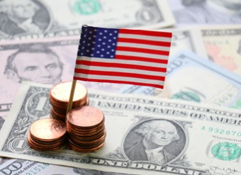 US flag sat on top of dollar notes