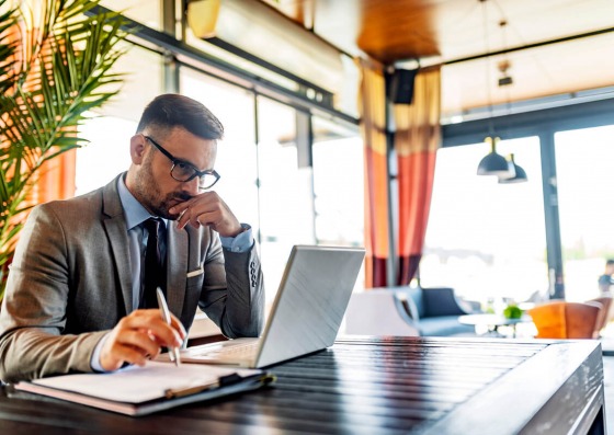 Adviser using a laptop in café