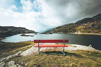 red bench overlooking reservoir 