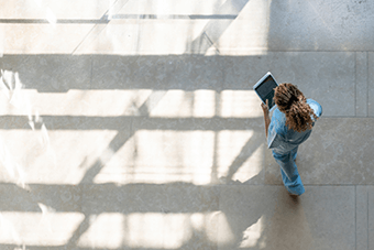 DOCTOR WALKING WITH PAD IN HAND
