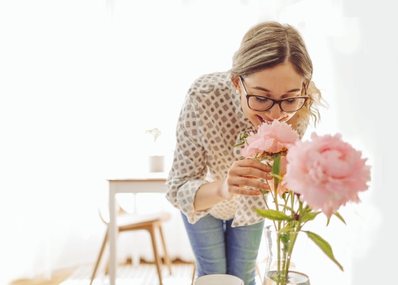 Lady smelling flowers