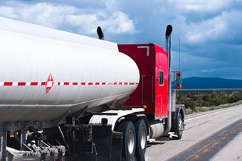 Red oil truck on road 