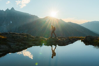 Image of person trekking across mountains