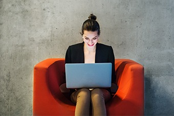 Red chair, women on laptop
