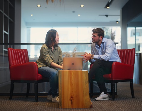 man and woman sat in a library