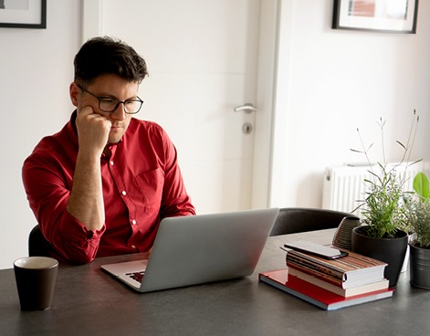 Man reading on laptop