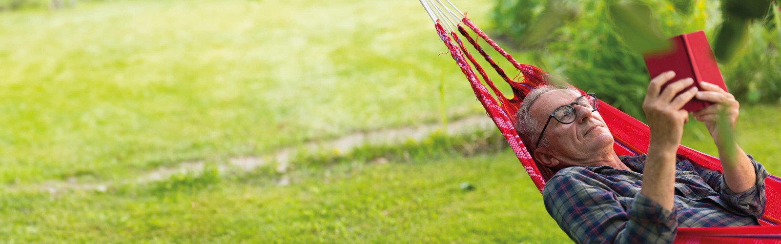 Man resting on a red hammock
