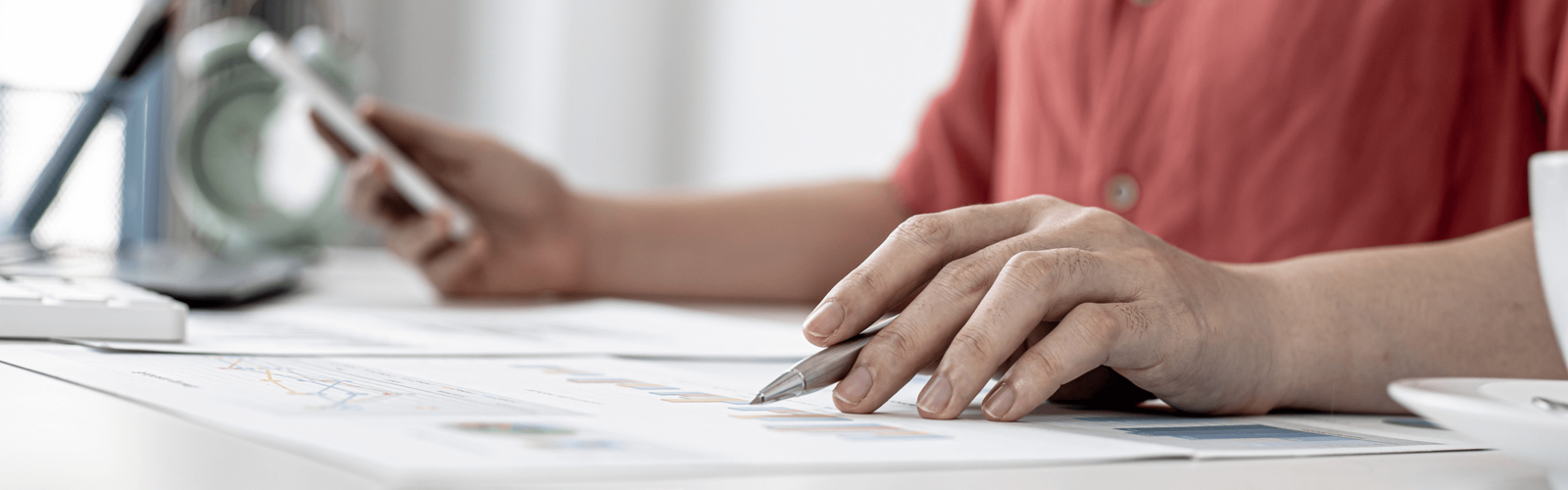 Woman writing whilst browsing on phone