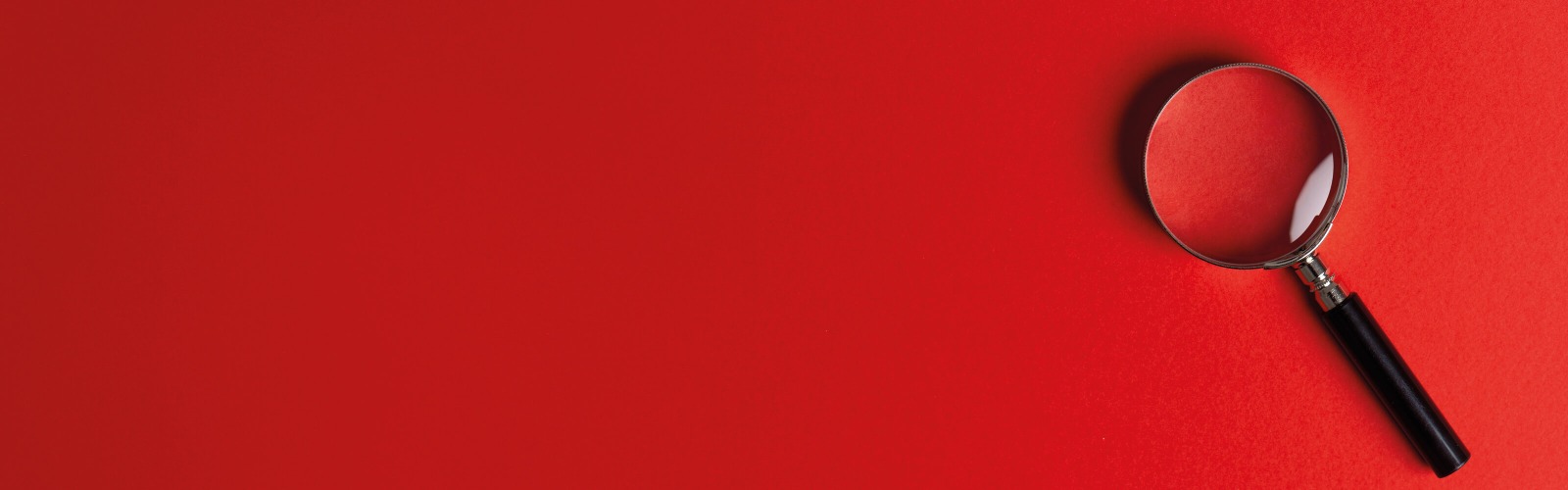 Magnifying glass on red background