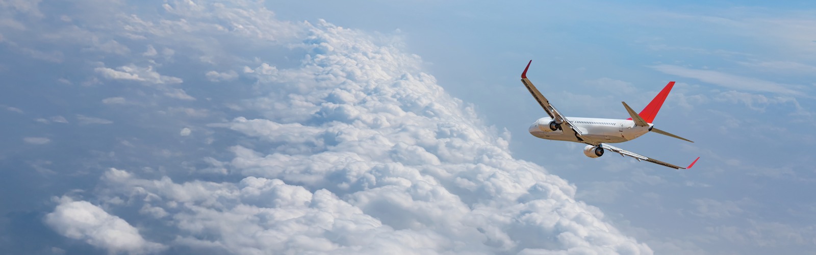 Plane flying against a blue sky