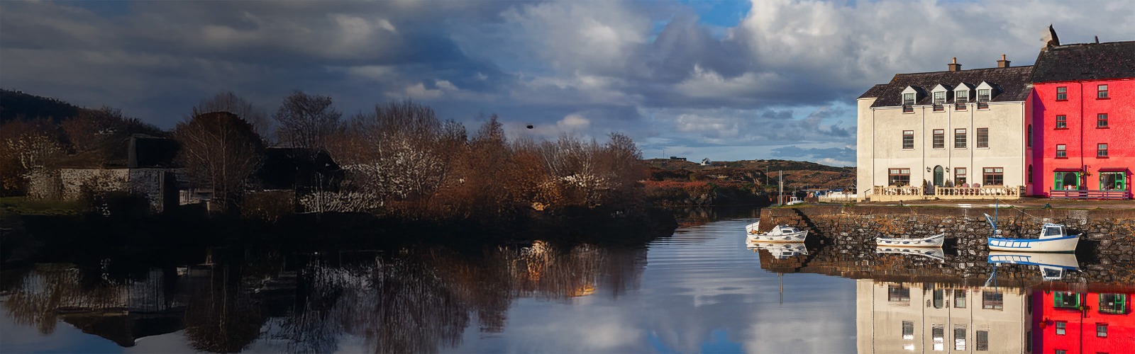 Two buildings next to lake reflecting on the water