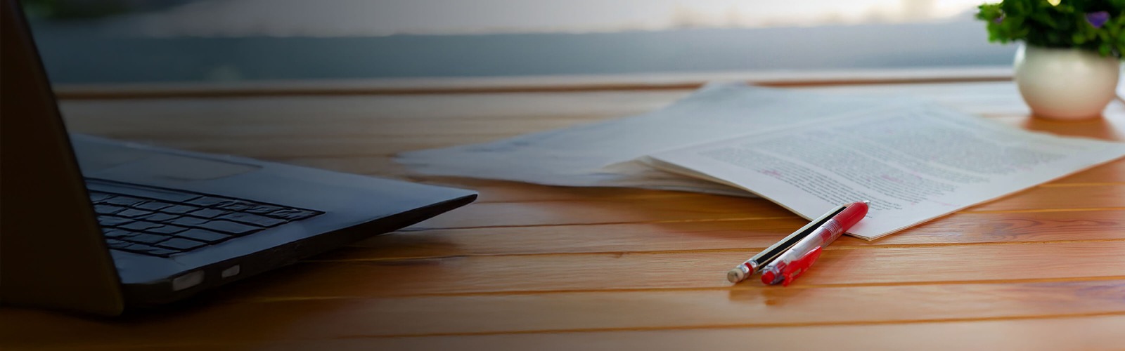 Red pen and paper on a table