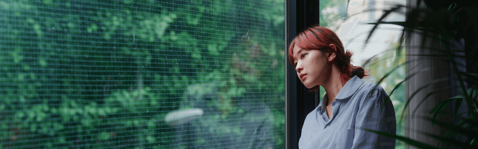 woman looking out window