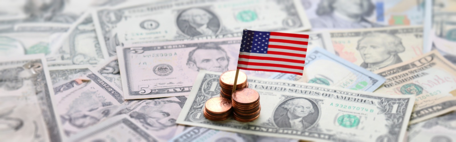 US flag sat on top of dollar notes
