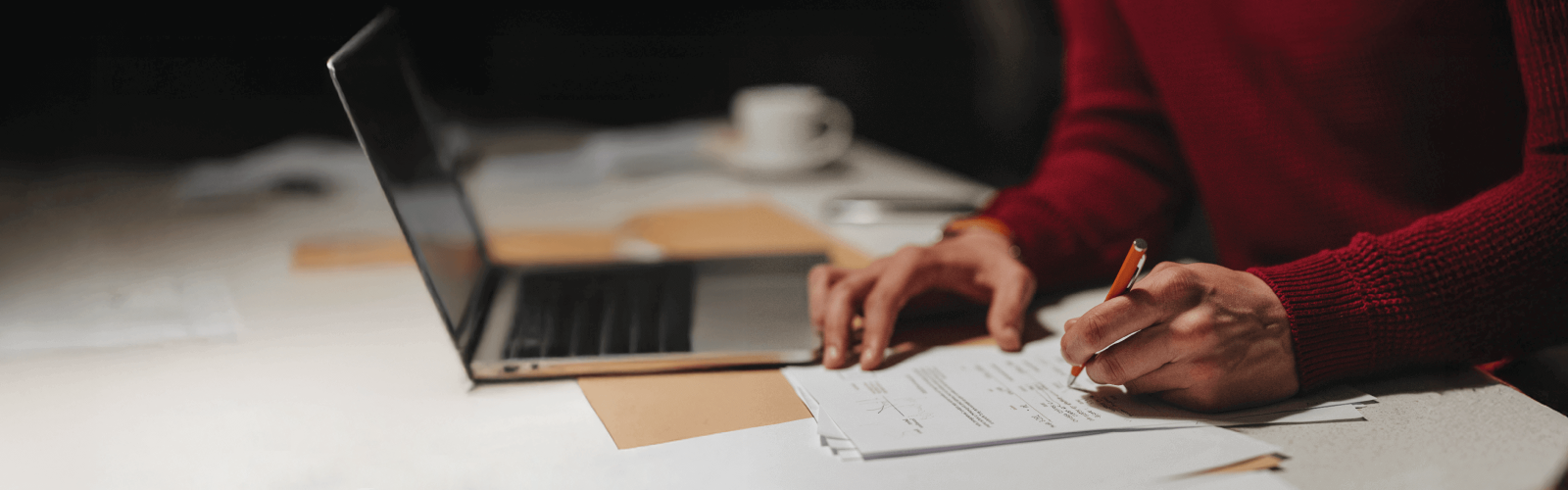 Person in a red jumper writing something 