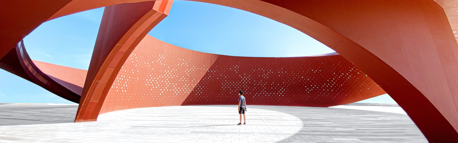 Man stood under red structure