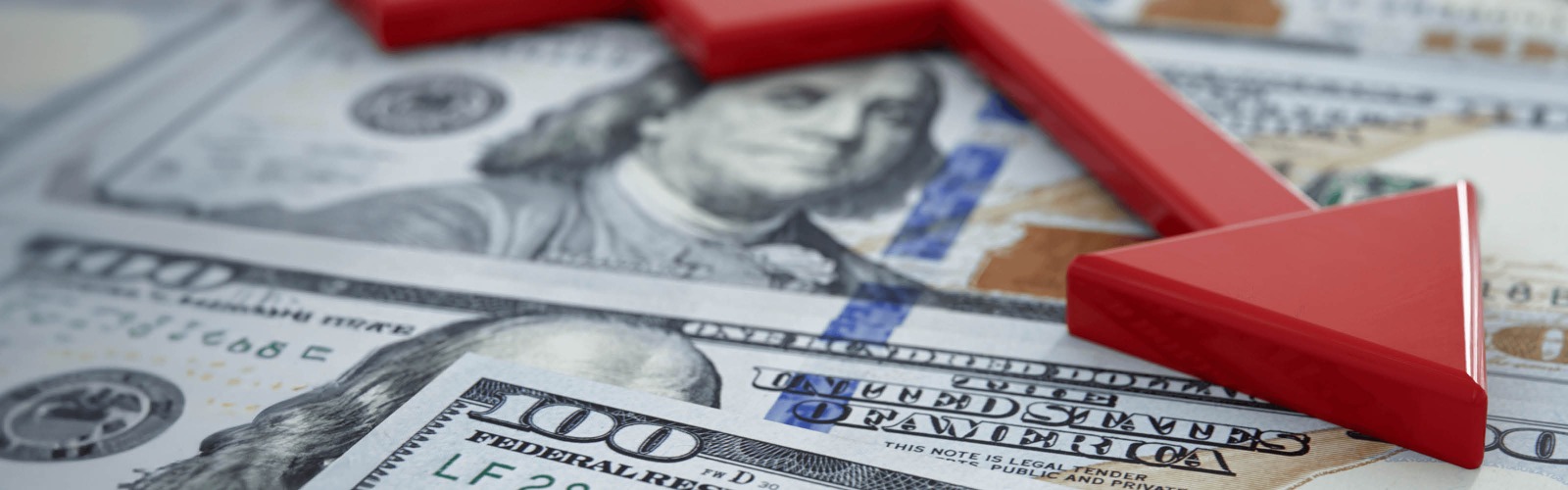 US dollar with red declining arrow overlaid 