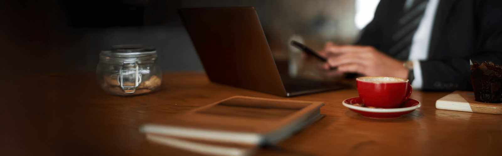 Person typing on laptop in coffee shop