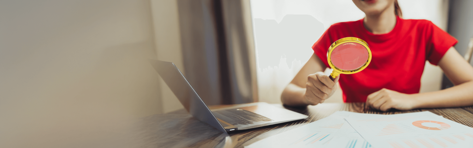 Woman looking through magnifying glass