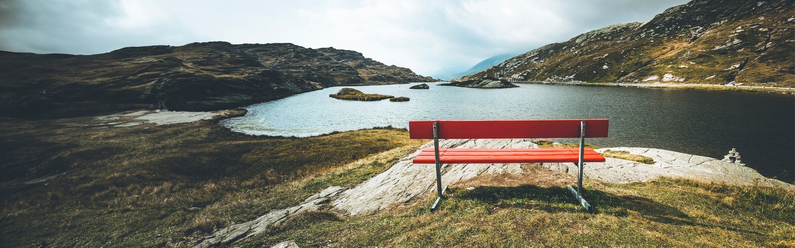 red bench overlooking reservoir 