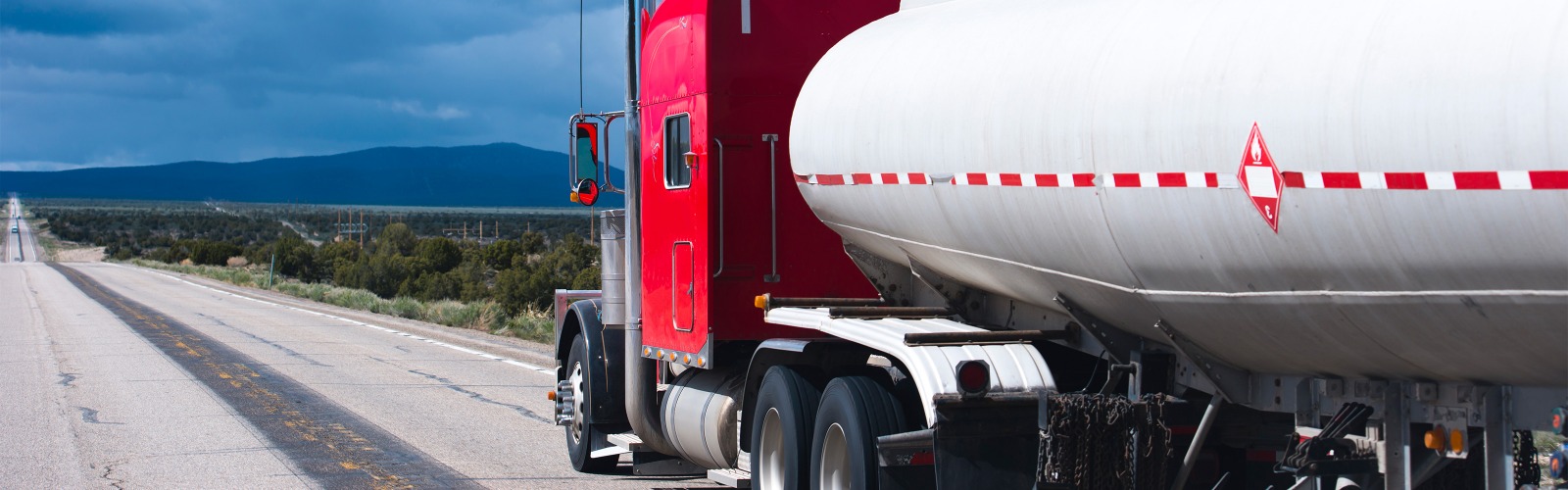 Red oil truck on road 
