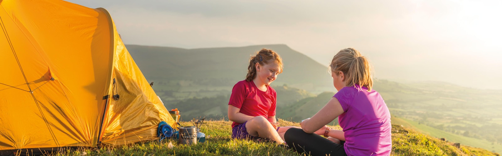 Two young girls camping