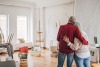 A couple hugging while decorating a room